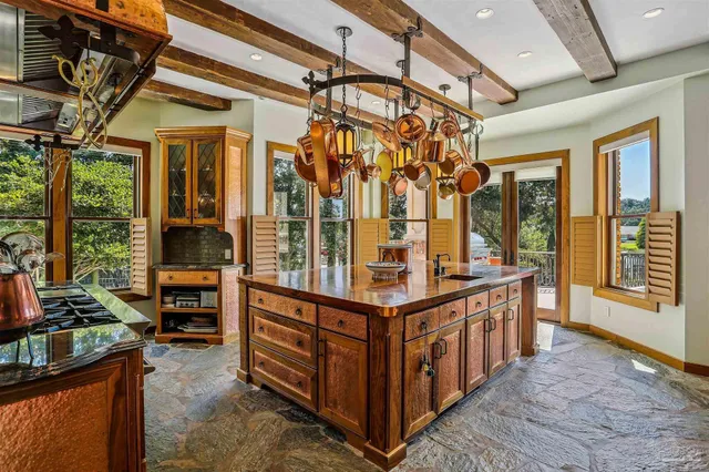 a living room with furniture a chandelier and a large window