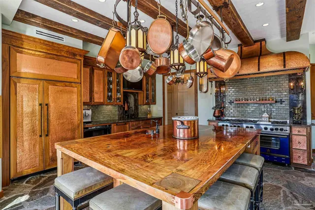 a living room with furniture a window and a chandelier