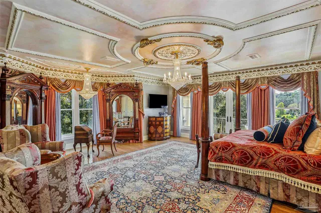 a living room with patio furniture and a chandelier