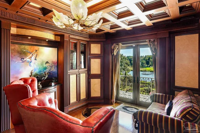 a dinning room with furniture a floor to ceiling window and potted plants