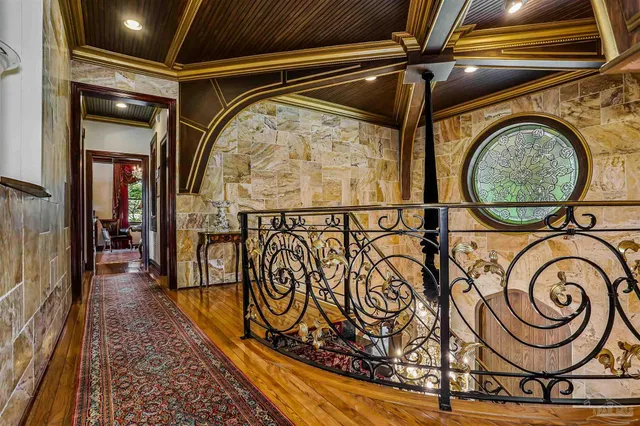 a living room with furniture a rug and a flat screen tv