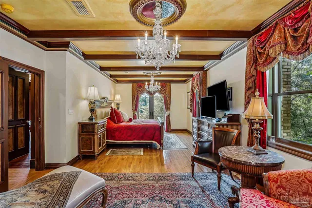 a bedroom with furniture and wooden floor