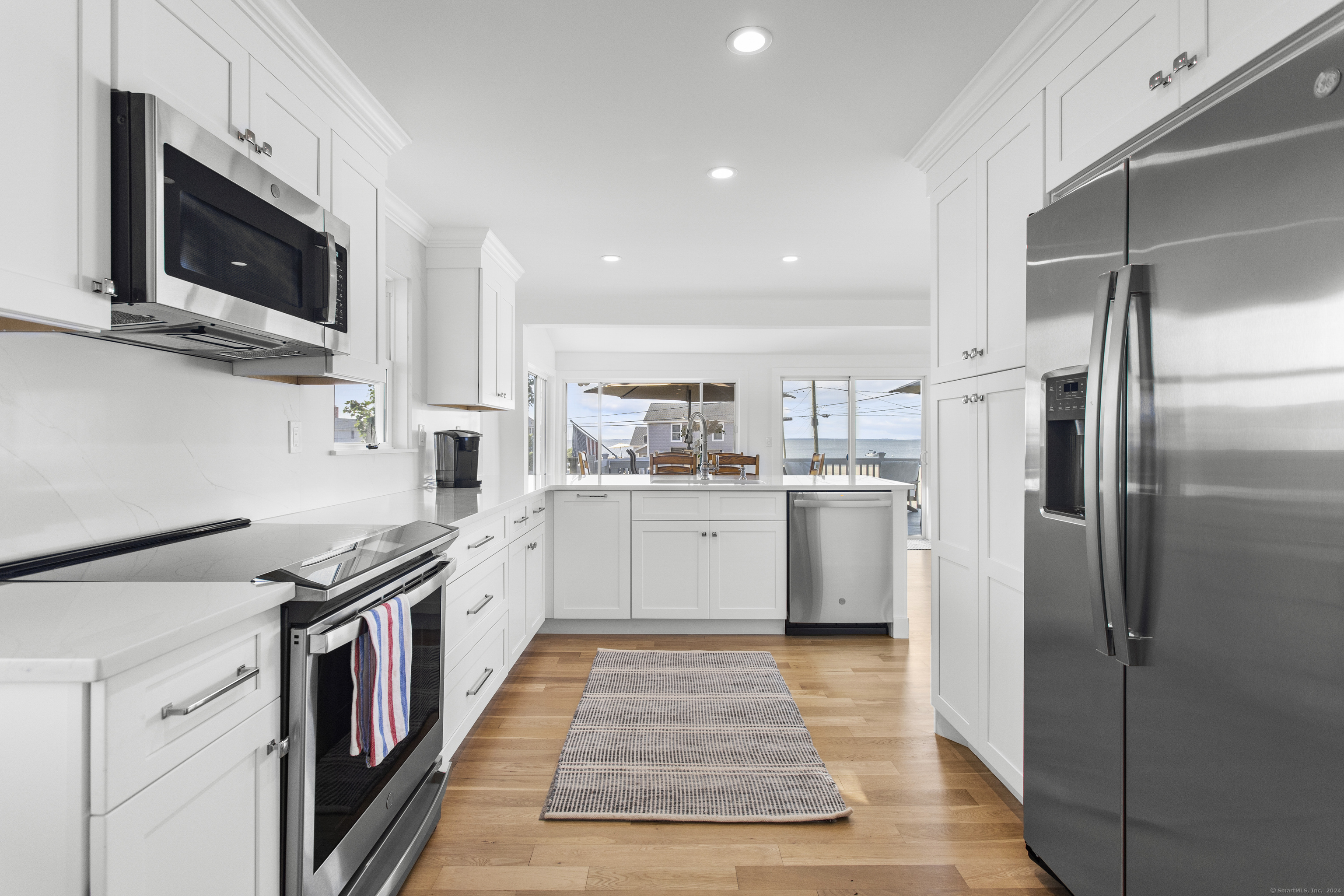 15 Cottage Road Old Lyme, CT 06371 - Photo 7 of 26 a kitchen with stainless steel appliances granite countertop a refrigerator a stove top oven a sink and dishwasher