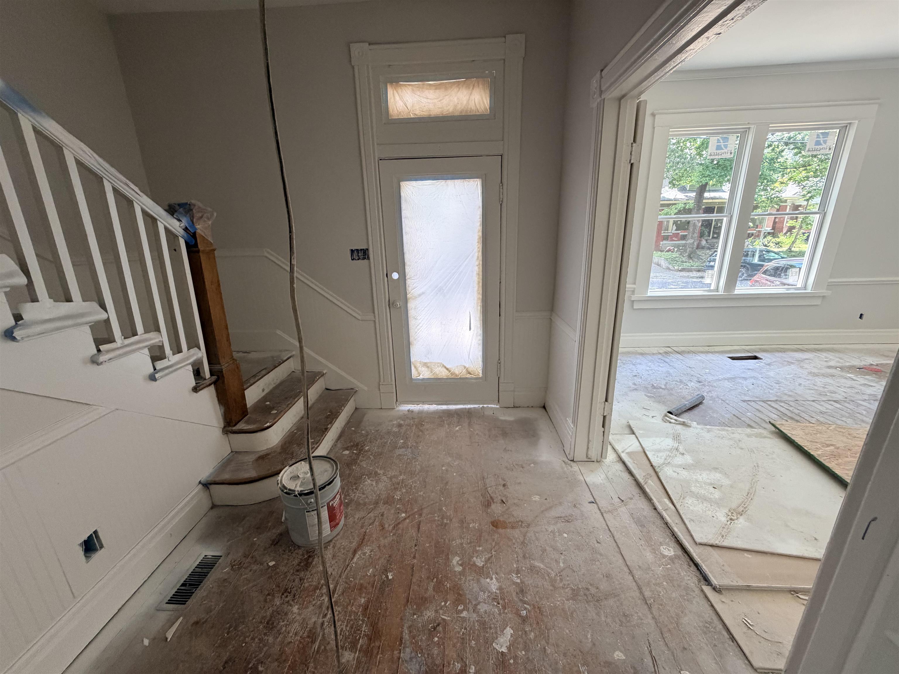 961 Meda Street Memphis, TN 38104 - Photo 22 of 27 Entry foyer with a prominent staircase featuring white balusters and a wood-finish newel post