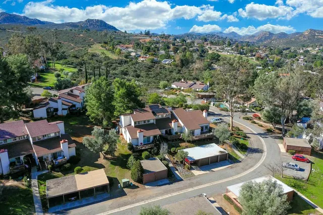 an aerial view of a houses with a street