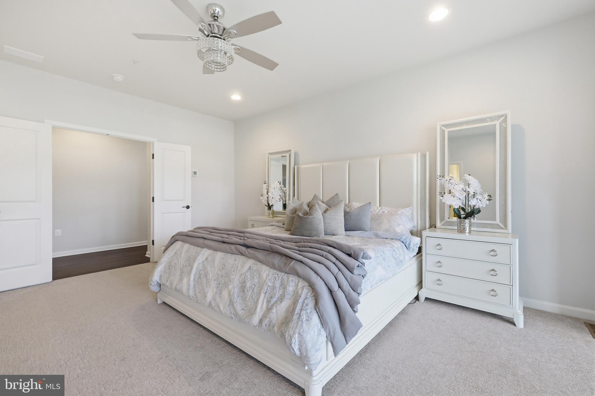 5707 Hawk Ridge Road Frederick, MD 21704 - Photo 36 of 109 a spacious bedroom with a bed and a chandelier