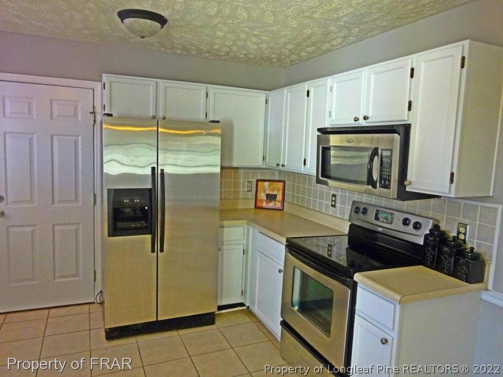 9841 Rockfish Road Raeford, NC 28376 - Photo 6 of 17 a kitchen with stainless steel appliances granite countertop a refrigerator a stove and a sink