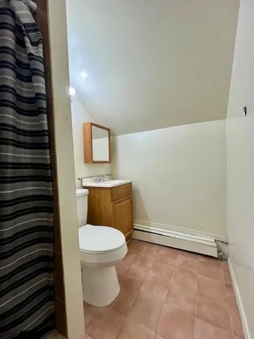 a toilet sitting in a bathroom next to a sink