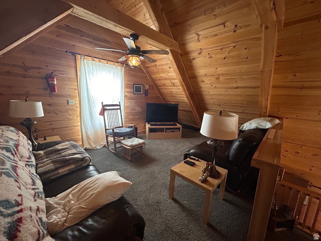 19075 West Honesty Cove Duchesne, UT 84021 - Photo 21 of 44 Attic space featuring wood plank walls and ceiling, exposed wood beams, and a ceiling fan with integrated lighting