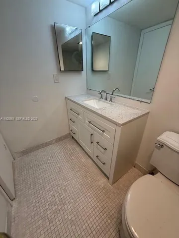 a bathroom with a sink a toilet and mirror