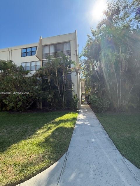 20381 Northeast 30th Avenue, Unit 2047 Aventura, FL 33180 - Photo 2 of 21 a view of a pathway both side of a house with a yard