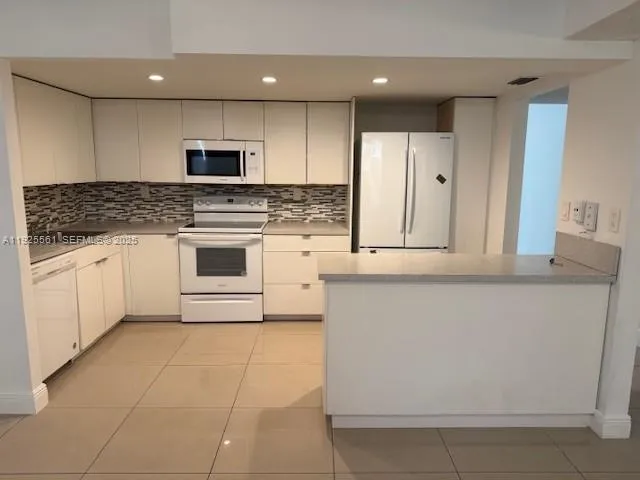 a kitchen with stainless steel appliances granite countertop a stove and a sink