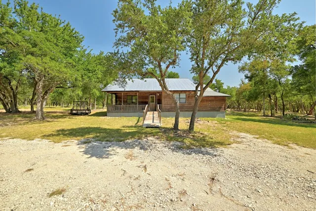 a view of a house with swimming pool and sitting area