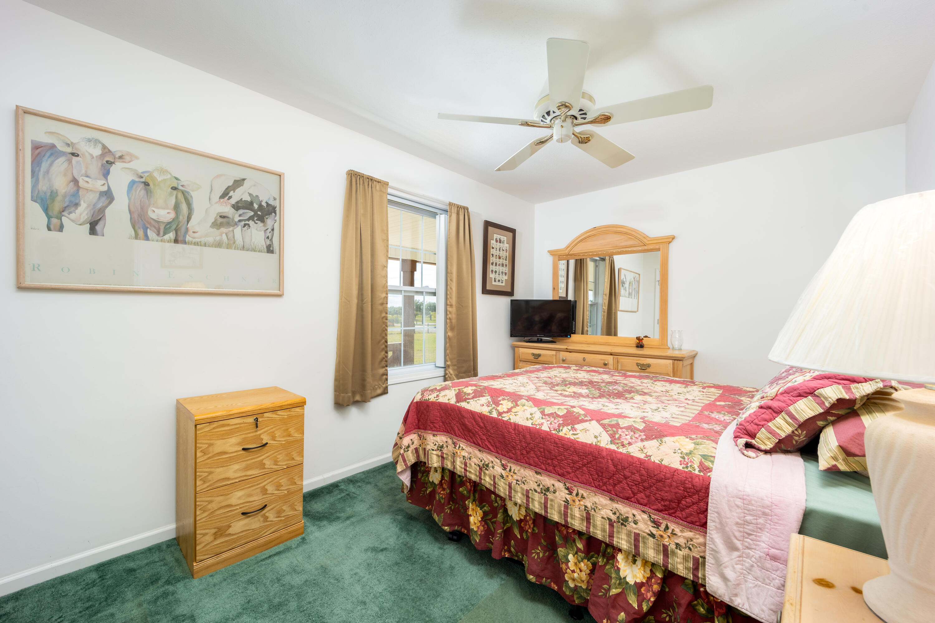 1101 Trowbridge Road Fort Pierce, FL 34945 - Photo 31 of 38 a bedroom with a bed a dresser and a window