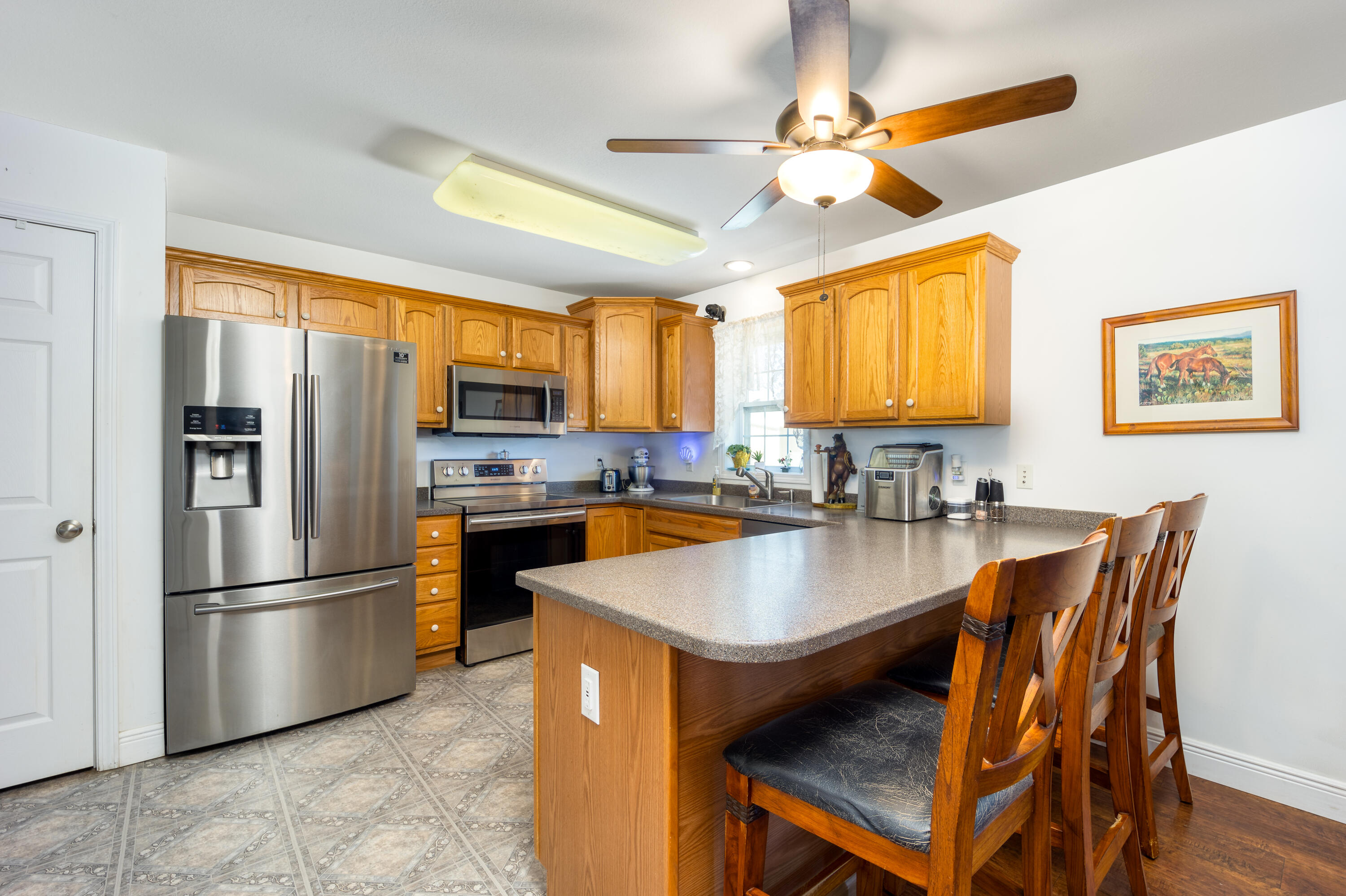 1101 Trowbridge Road Fort Pierce, FL 34945 - Photo 6 of 38 a kitchen with stainless steel appliances granite countertop a refrigerator a stove a sink a dining table and chairs