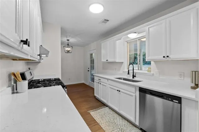 a kitchen with a sink and cabinets