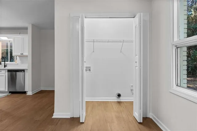 a view of a room with wooden floor and windows