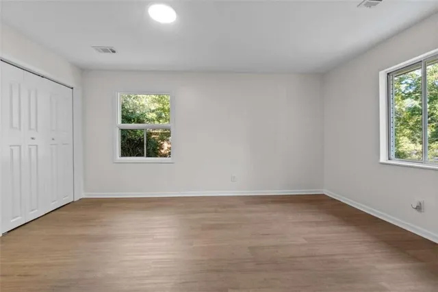 wooden floor in an empty room with a window
