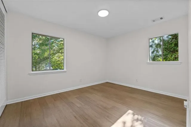 wooden floor in an empty room with a window