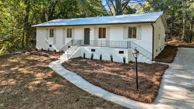 a front view of a house with garden