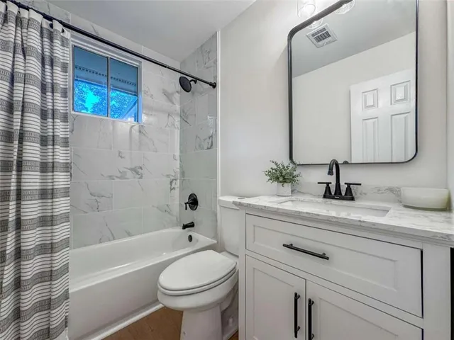 a bathroom with a sink a toilet and a bathtub