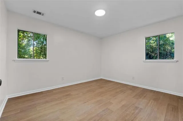 wooden floor in an empty room with a window