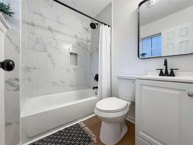 a bathroom with a bathtub and a toilet
