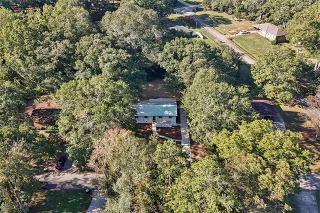 an aerial view of a house with a yard