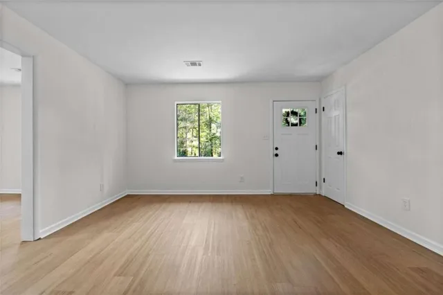 wooden floor in an empty room with a window