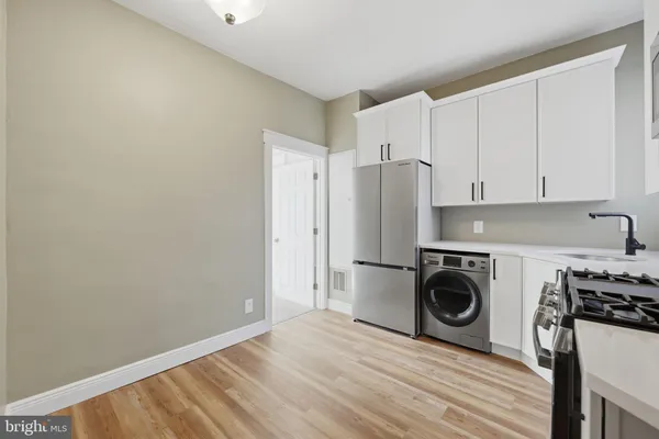 a view of a kitchen with washer and dryer
