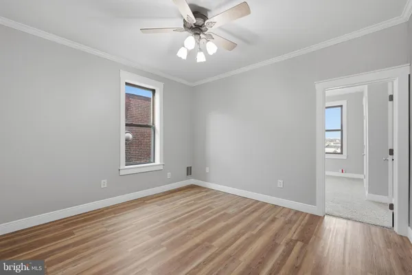 wooden floor in an empty room with a window