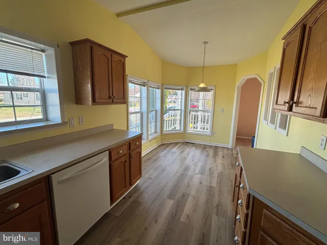 a kitchen with wooden floors and sink