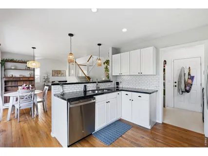 a kitchen with granite countertop a stove and cabinets