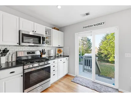 a kitchen with stainless steel appliances a stove a sink and a microwave