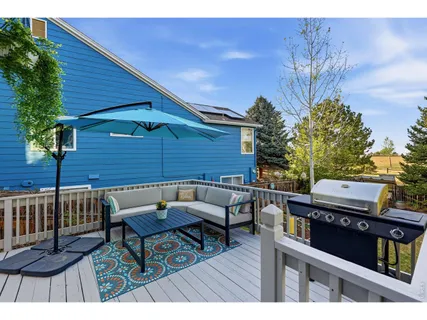 a roof deck with a table and chairs