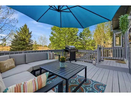 a view of a wooden deck with furniture