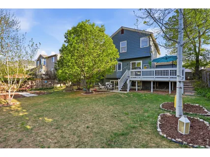 a view of a house with a yard next to a lake