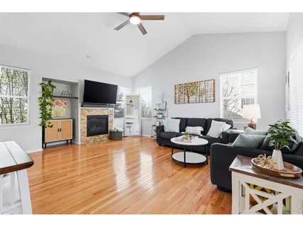 a living room with fireplace furniture and a flat screen tv