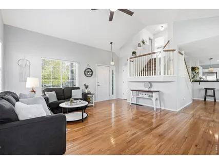 a living room with furniture and a wooden floor