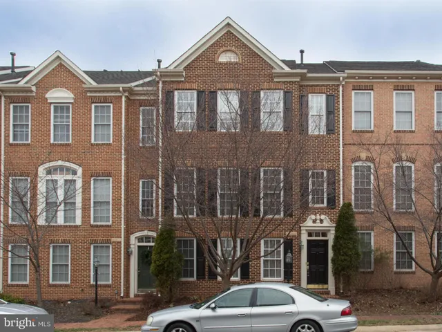 a front view of a residential apartment building with a yard