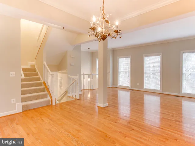 a view of an room with wooden floor and windows