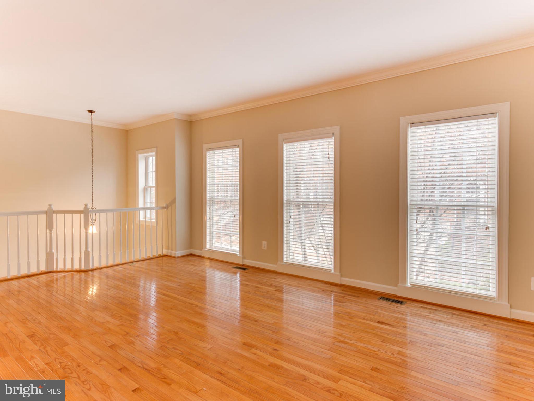 43802 Bent Creek Terrace Leesburg, VA 20176 - Photo 15 of 40 a view of an empty room with wooden floor and a window