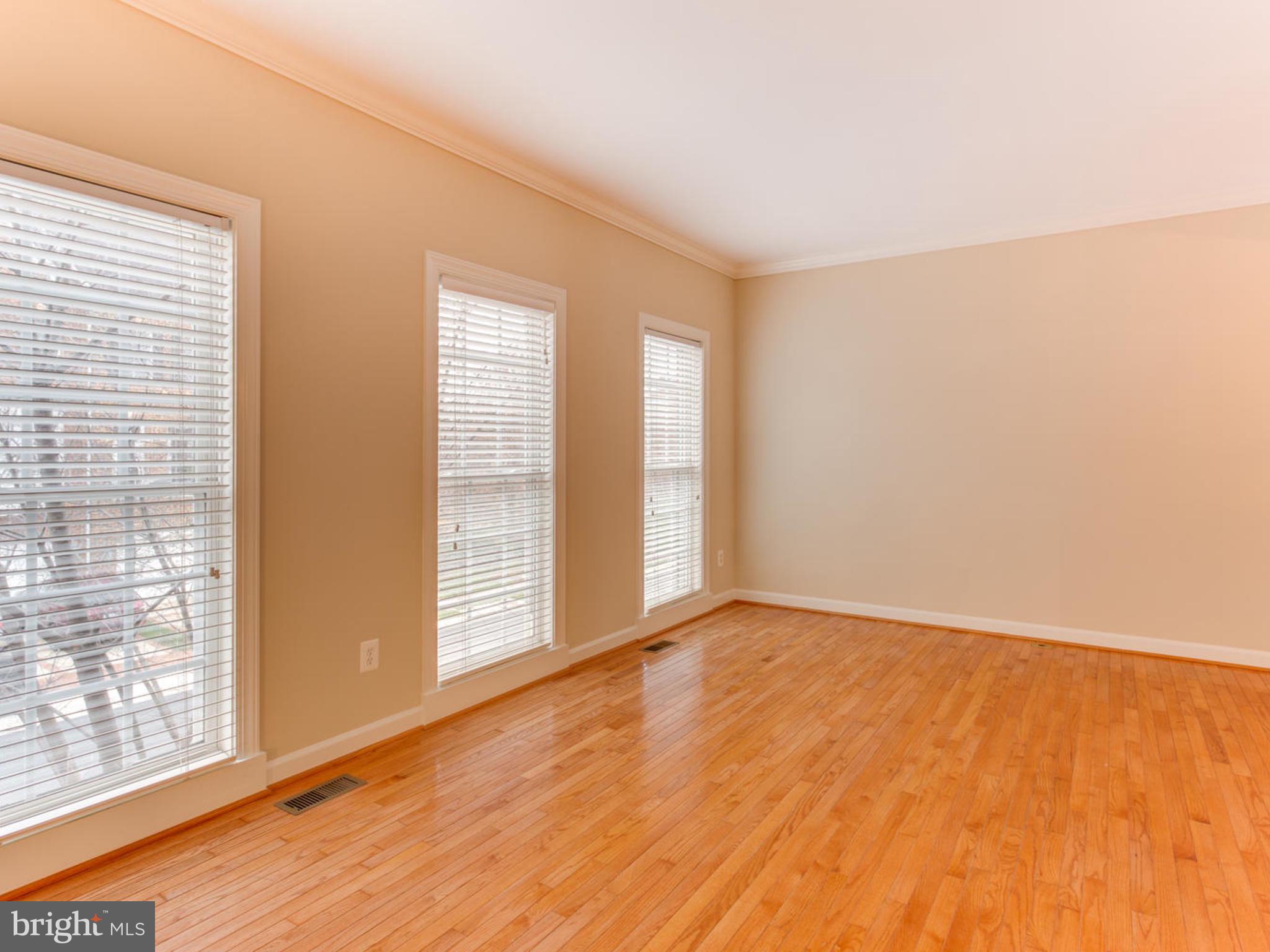 43802 Bent Creek Terrace Leesburg, VA 20176 - Photo 16 of 40 a view of an empty room with wooden floor and a window