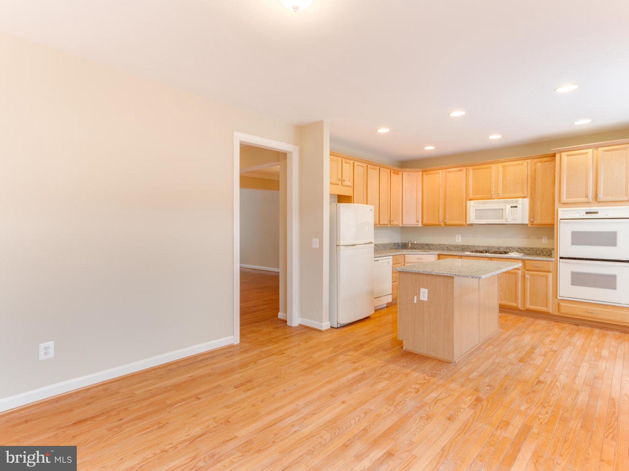 43802 Bent Creek Terrace Leesburg, VA 20176 - Photo 19 of 40 a kitchen with stainless steel appliances granite countertop a refrigerator and a stove top oven