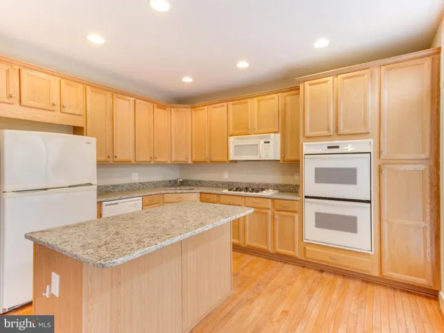 a kitchen with stainless steel appliances granite countertop a refrigerator sink and cabinets