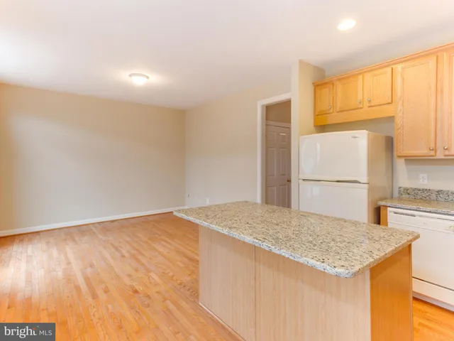 a kitchen with a sink a refrigerator and a stove top oven