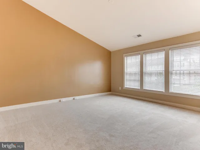 an empty room with a windows