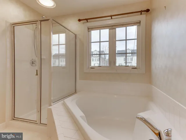 a bathroom with a bathtub and a shower