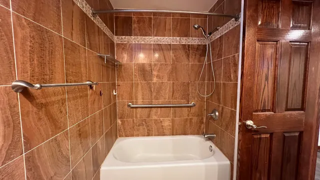 a bathroom with a bathtub and a shower