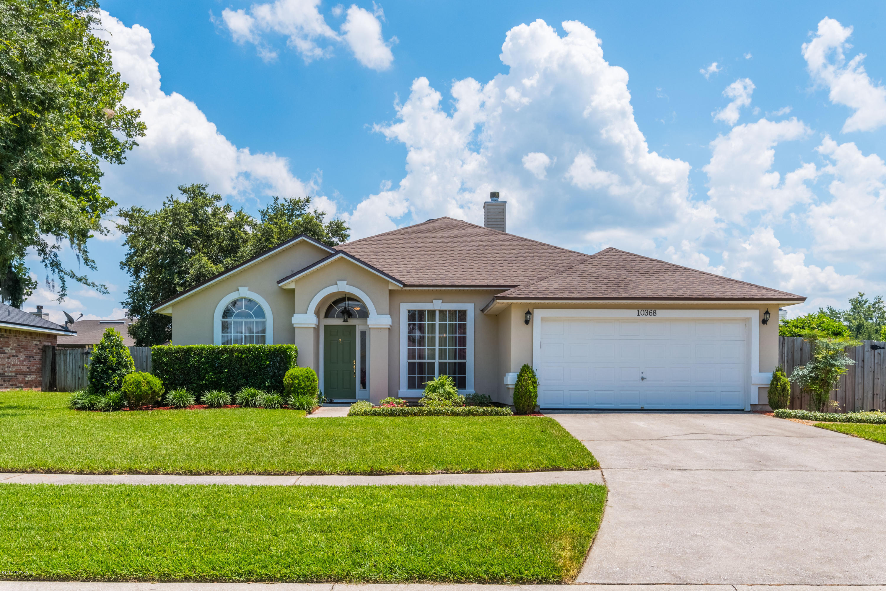 10368 Sugar Grove Road Jacksonville, FL 32221 - Photo 1 of 28 a front view of a house with a garden